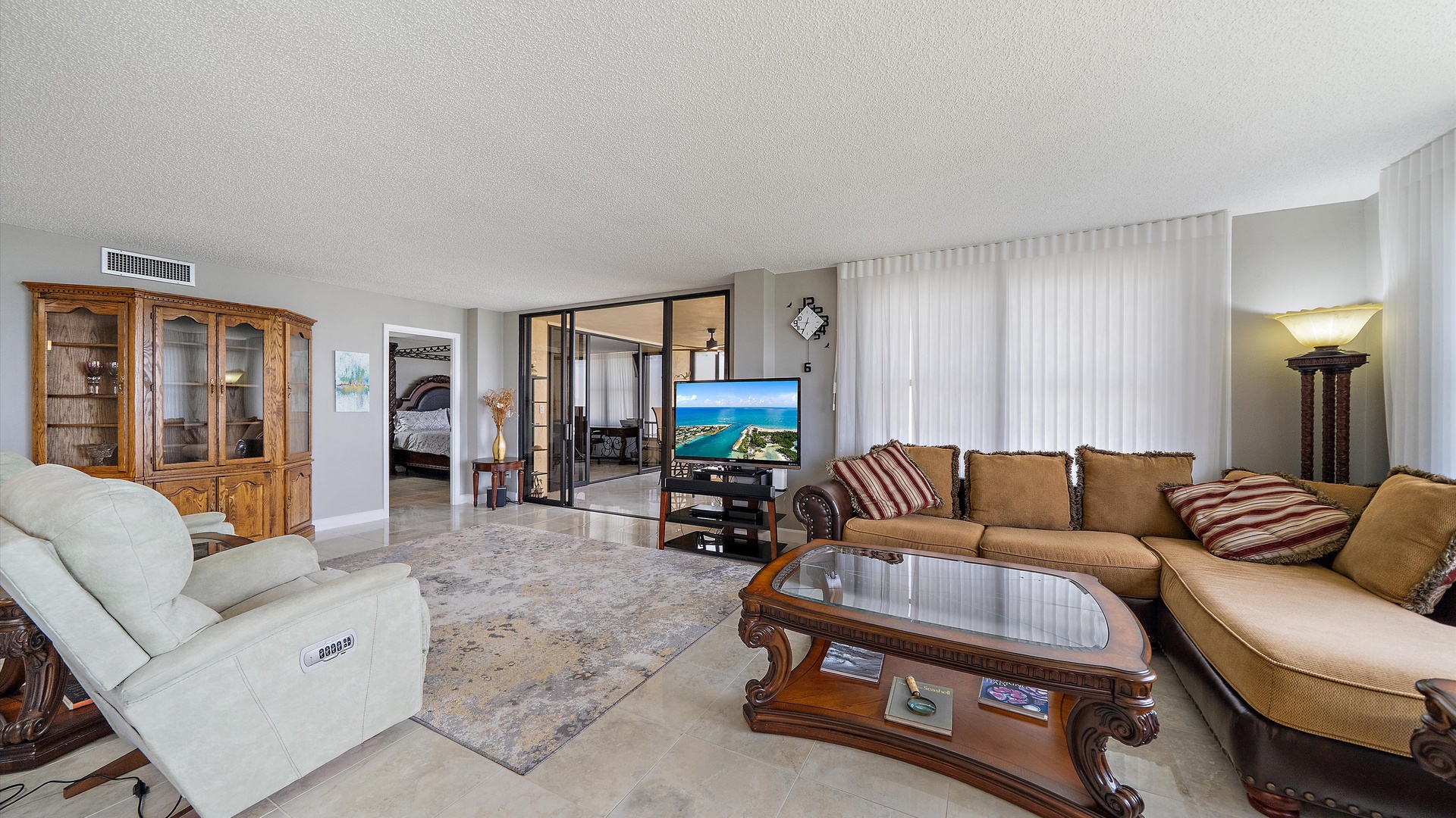 Relax in your spacious living room with elegant furnishings, stunning ocean views, and seamless access to your private bedroom suite.