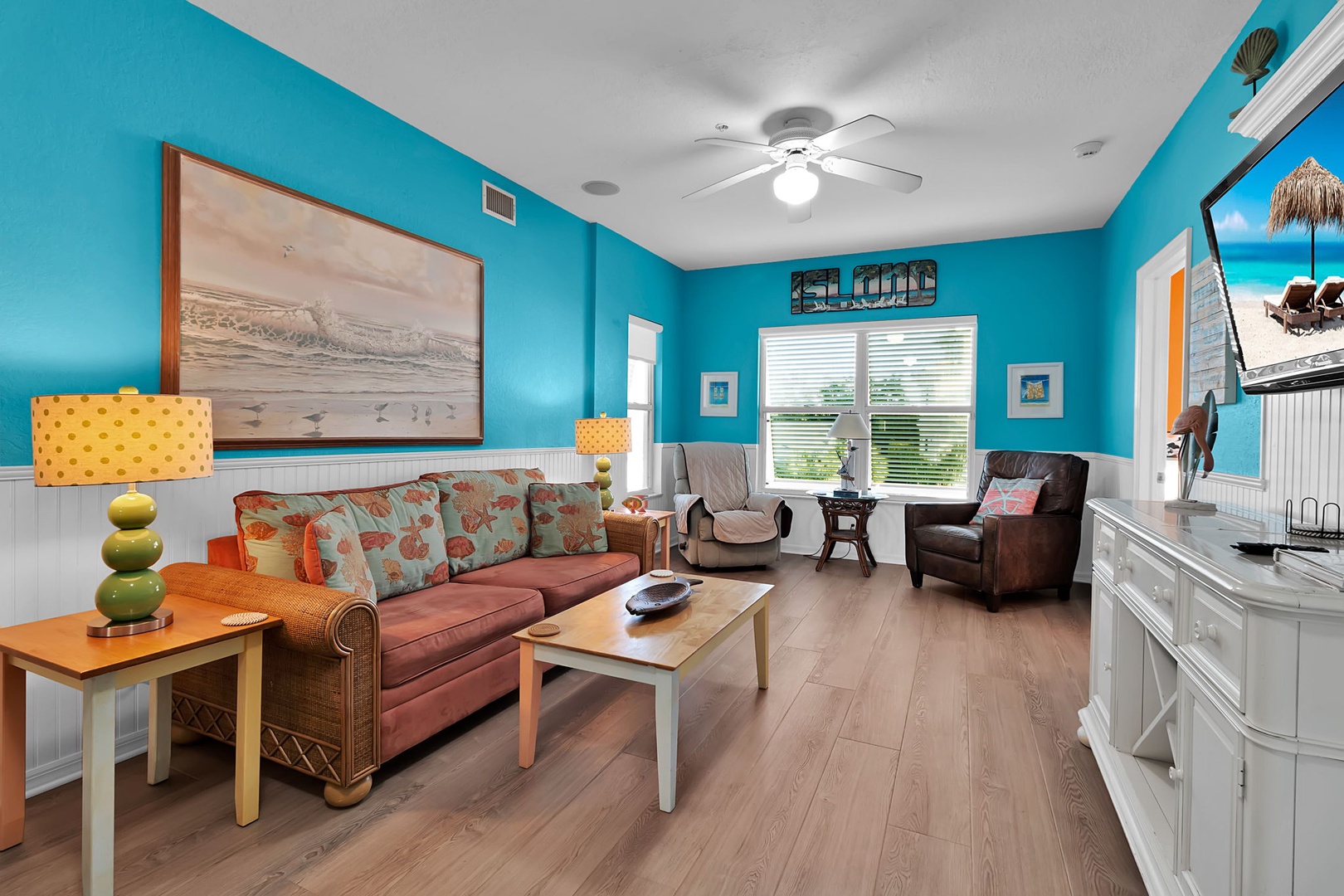 Sink into plush coastal comfort in your vibrant living space, where cheerful pops of color and beach-inspired décor invite you to relax and unwind after a day of adventure.