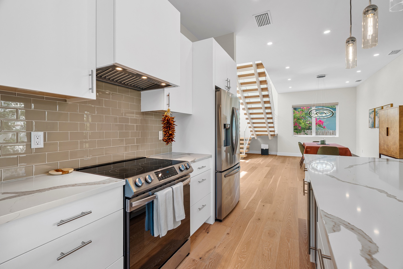 Bright, modern kitchen with gleaming countertops and everything you need to whip up a memorable meal. The open layout flows seamlessly into your living area, making it easy to gather and unwind.