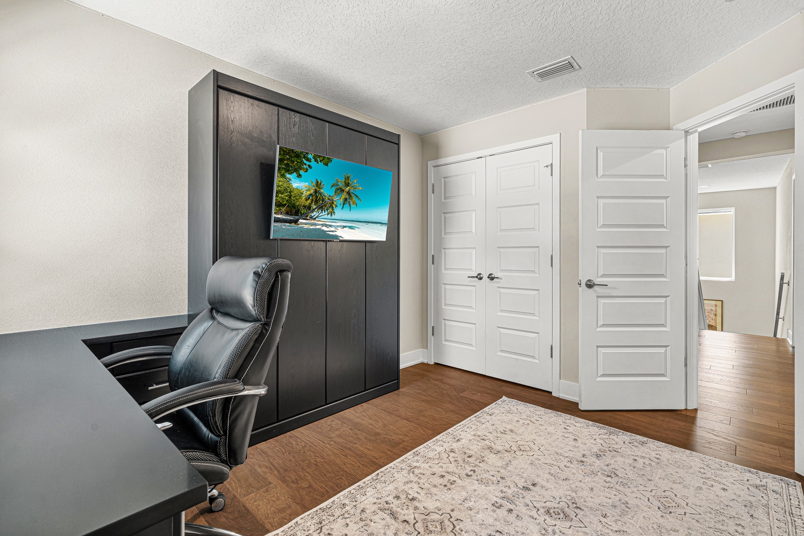 Set up your workspace in this sleek home office with modern built-in storage and a comfortable desk area—perfect for staying productive during your getaway.