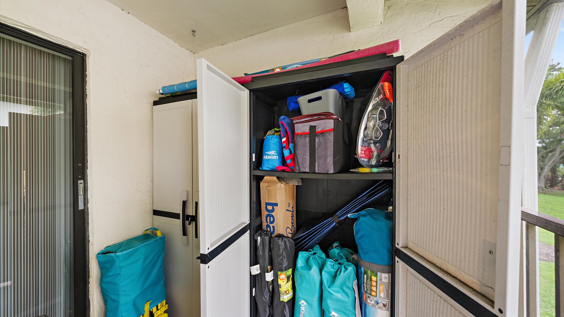 A storage cabinet keeps beach and outdoor gear organized and ready for your next adventure.