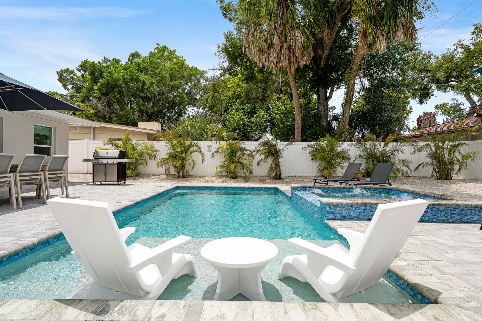 Cool off in this sparkling pool with in-water loungers.