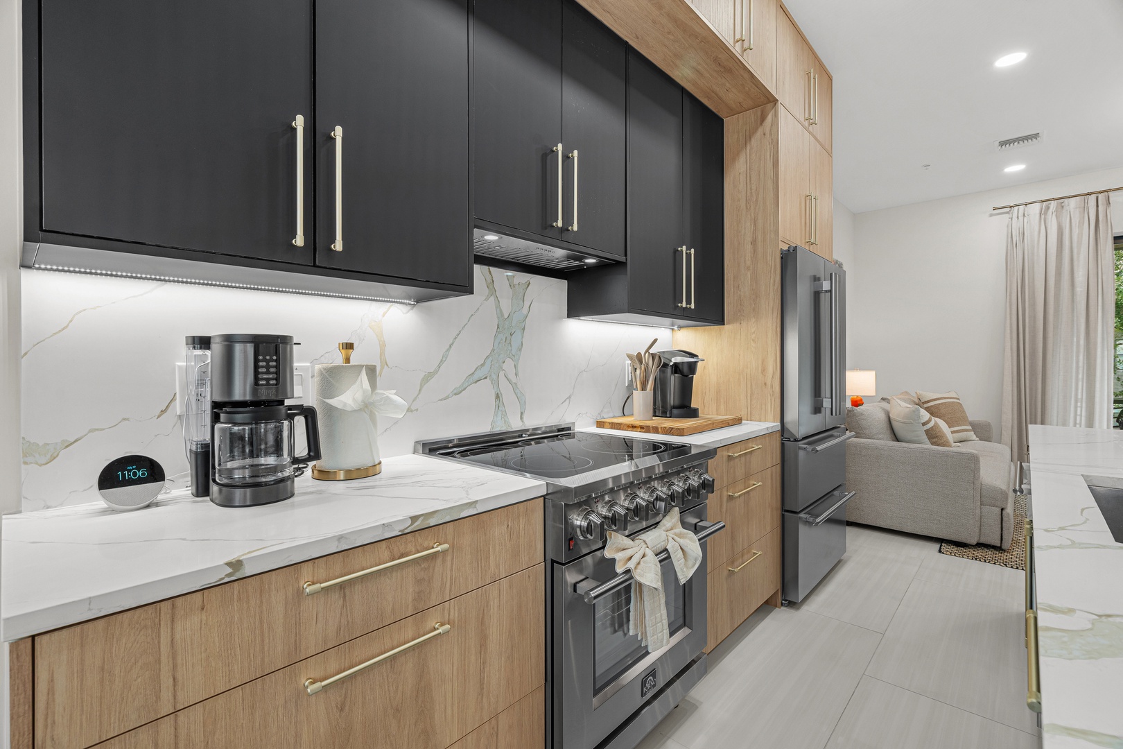 Your fully equipped kitchen features sleek cabinetry, marble-look backsplash, stainless appliances, and everything you need to prepare delicious meals during your stay.