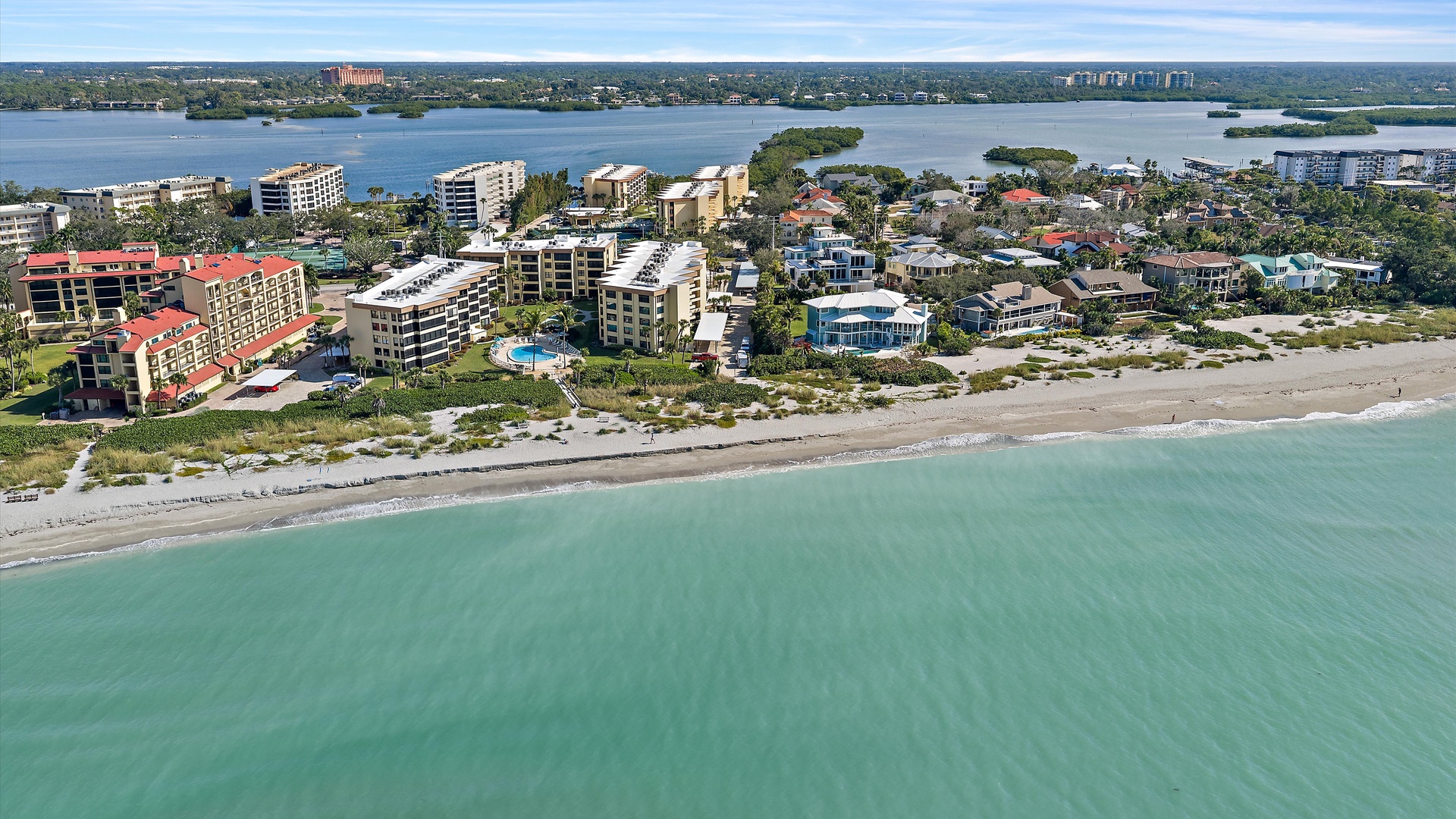 Stunning beachfront location with pristine turquoise waters and white sand beach just steps away from waterfront accommodations.