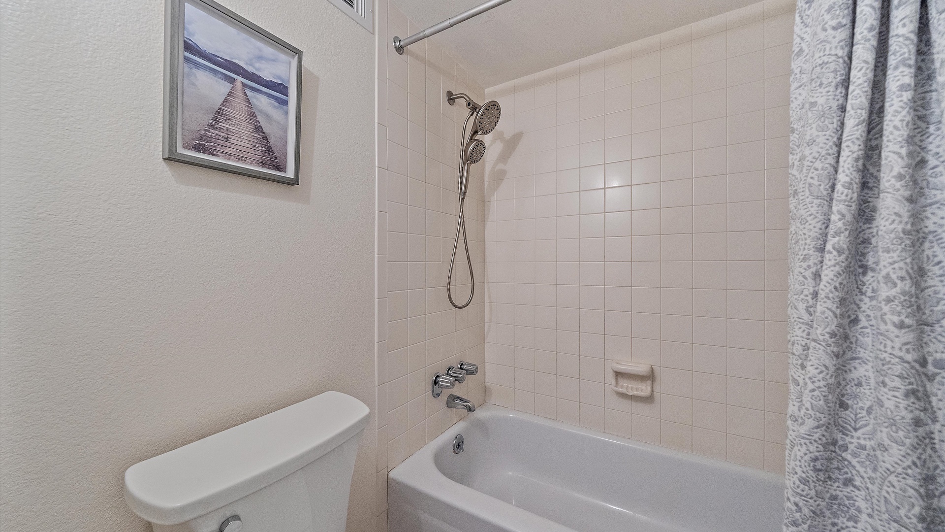 Your clean, well-appointed bathroom features a relaxing tub/shower combo with modern fixtures and thoughtful touches like framed artwork to make you feel at home.