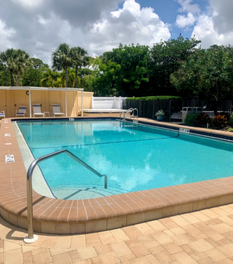 Lounge poolside after a day at the beach. Pool loungers and umbrellas available for guest use.
