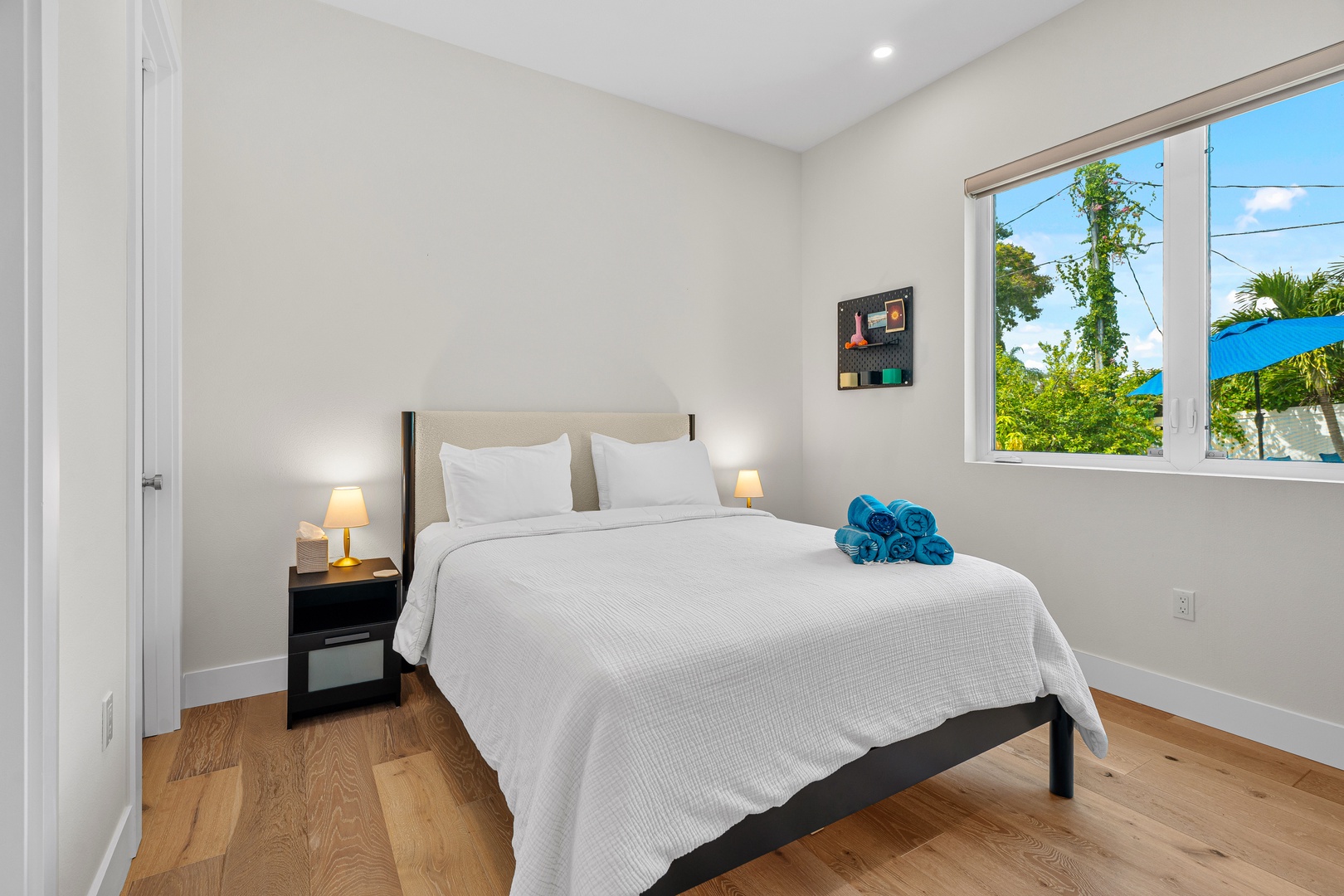 Sink into crisp white linens and let natural light fill your airy bedroom. You'll love the peaceful ambiance, warm wood floors, and thoughtful touches like plush towels awaiting your arrival.