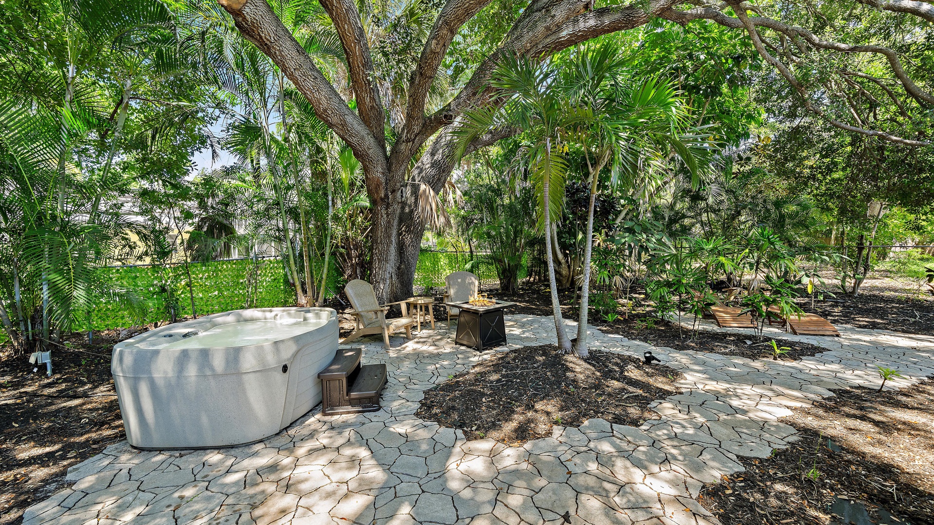 Escape to your private jungle oasis complete with a spacious hot tub, fire pit, and tropical garden setting—a peaceful retreat where relaxation is effortless.