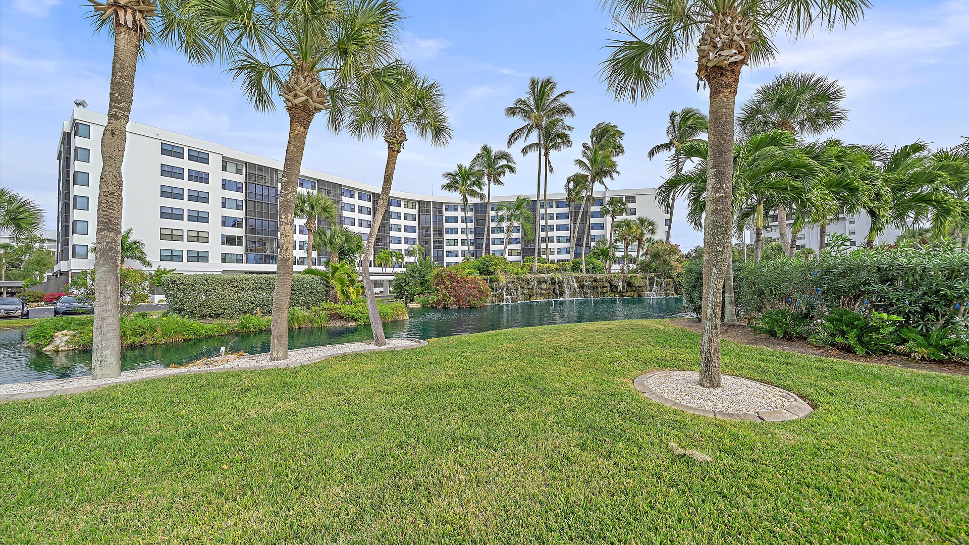 Resort property featuring tropical landscaping with palm trees and waterfront positioning in a scenic coastal setting.