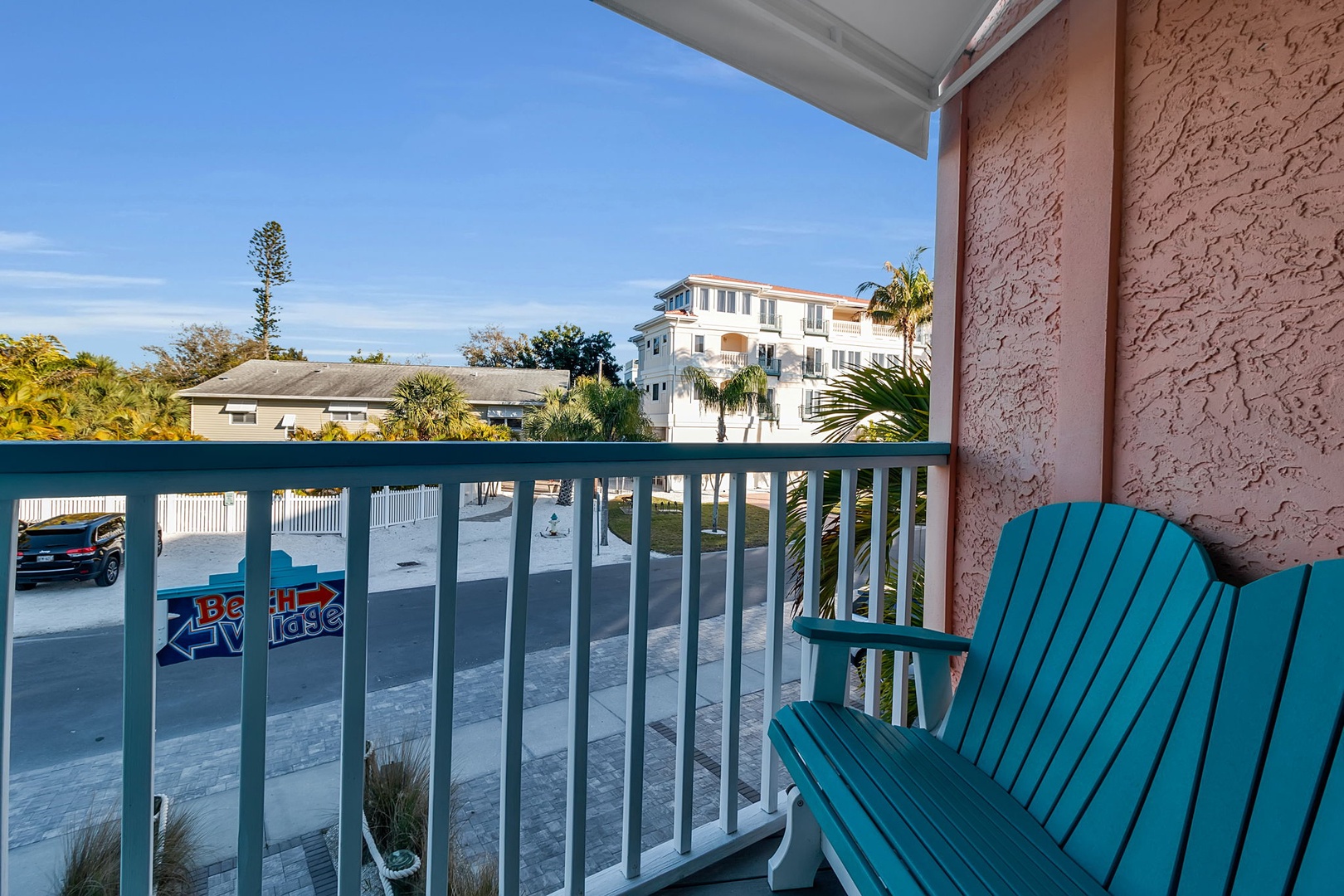 Your balcony offers a cheerful spot to sip morning coffee while taking in views of palm trees, blue skies, and the quiet neighborhood streets below.
