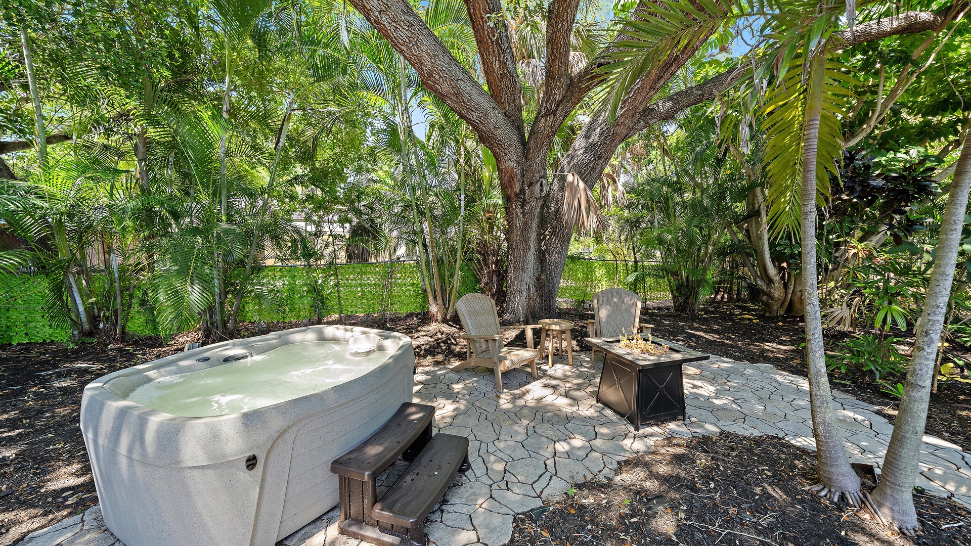 Slip into your private hot tub surrounded by lush tropical palms, then gather around the fire pit for evening relaxation under swaying fronds and open sky.