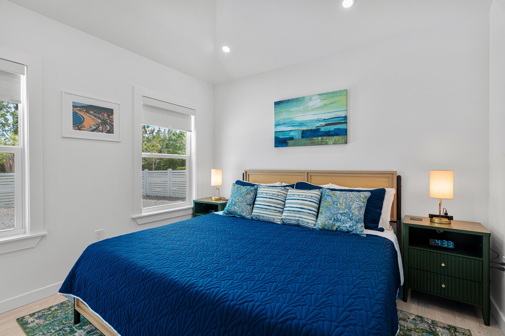 Sink into this serene bedroom where coastal artwork and soft natural light welcome you to unwind after your day of exploring.