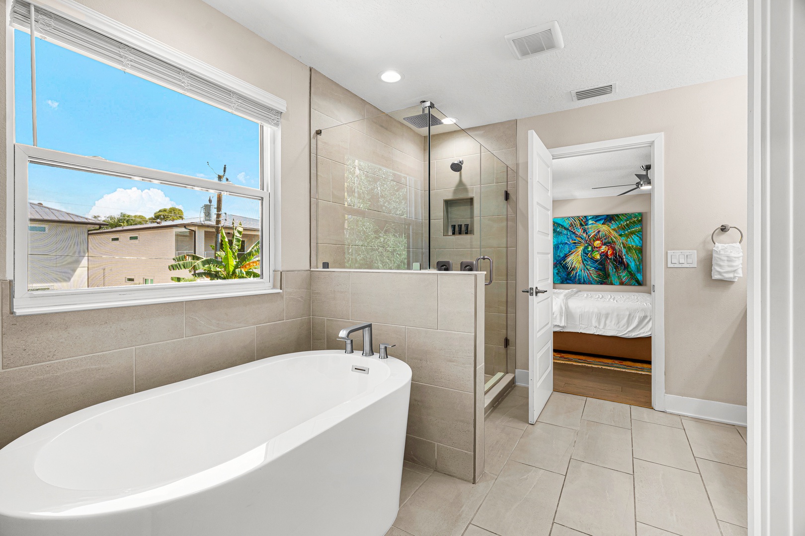 Soak away your cares in your private spa-like bathroom. A sleek freestanding tub, modern walk-in shower, and plenty of natural light create the perfect retreat after exploring the area.