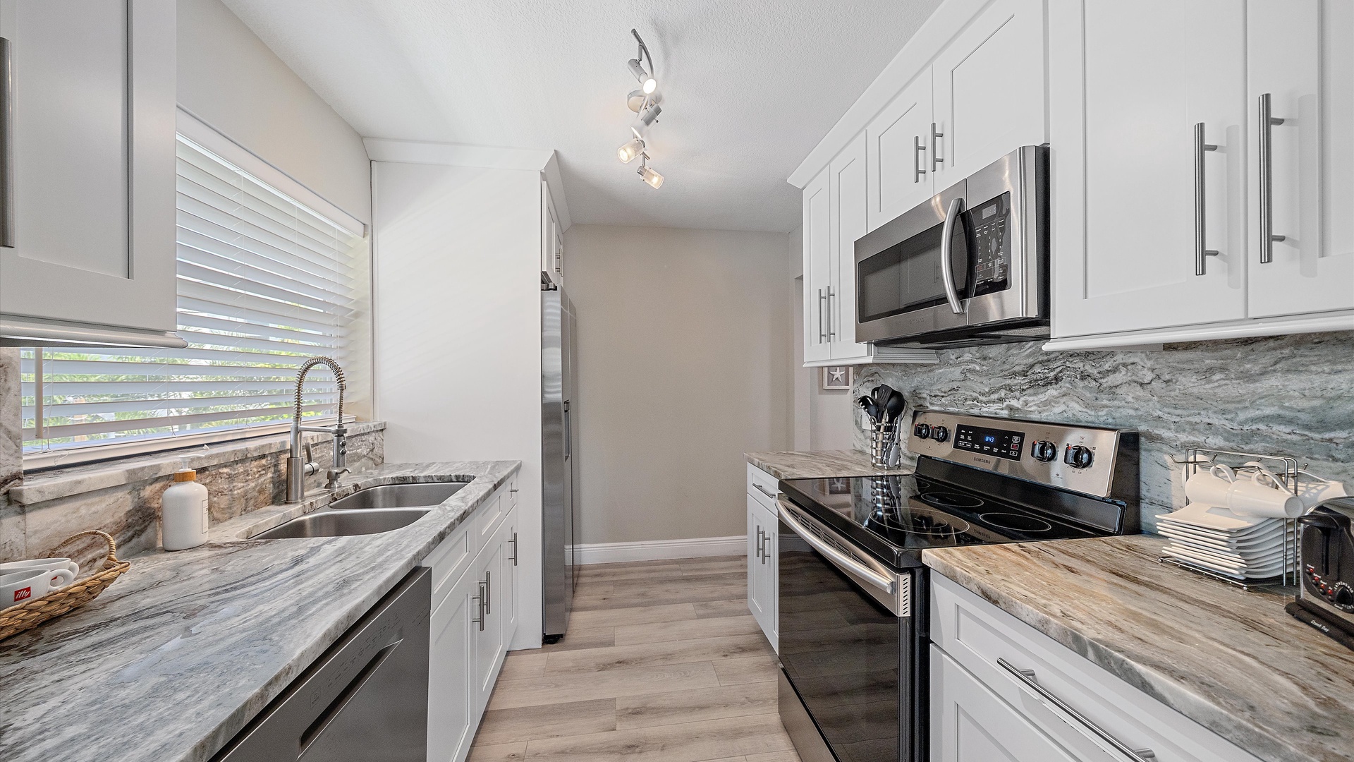 Your fully equipped kitchen awaits with sleek countertops, modern appliances, and plenty of space to prepare meals together. Natural light pours in, making every breakfast and snack feel bright and welcoming.