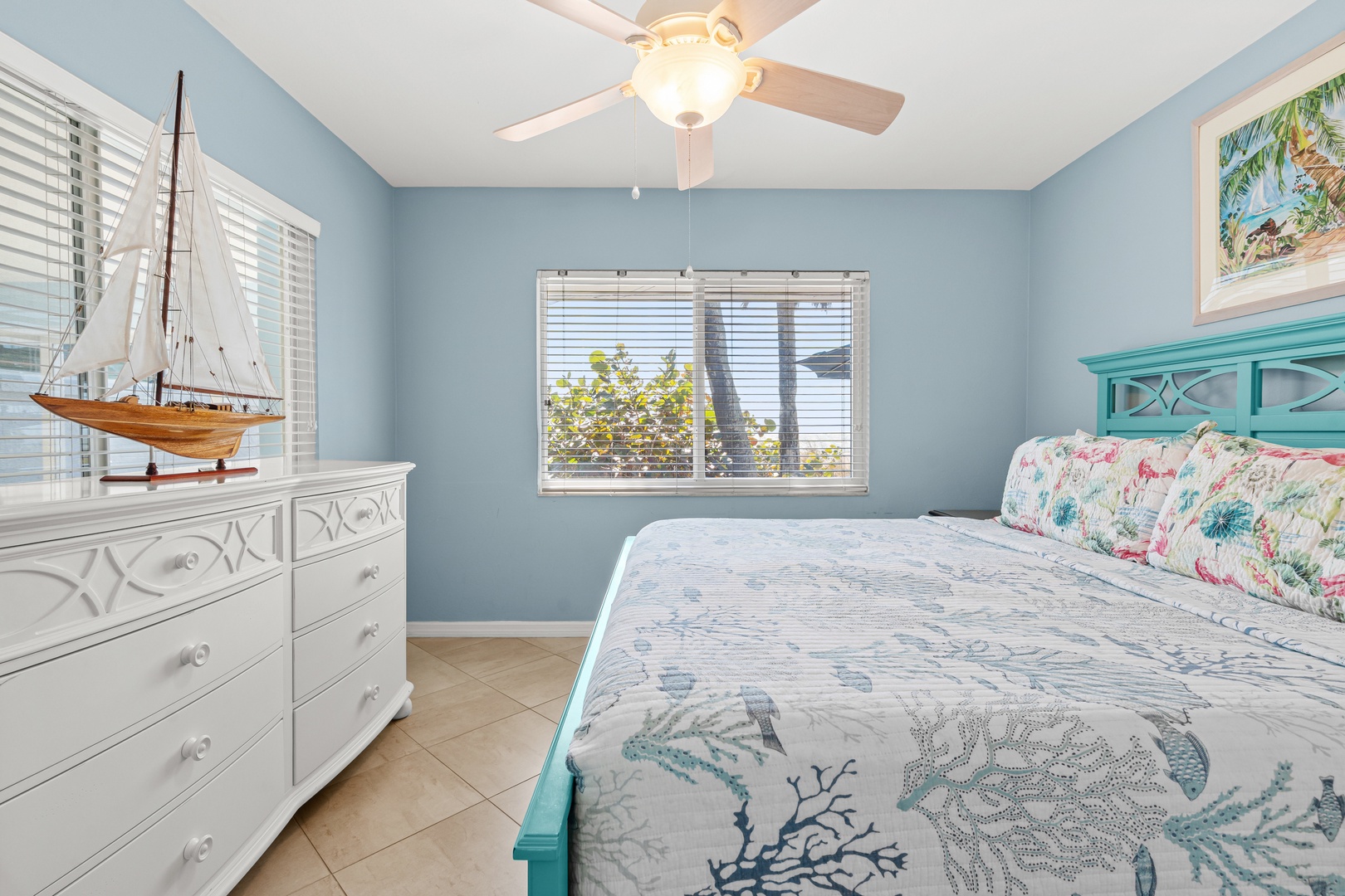 Drift off to peaceful slumber in your coastal-themed bedroom with ocean views and gentle breezes from the ceiling fan.