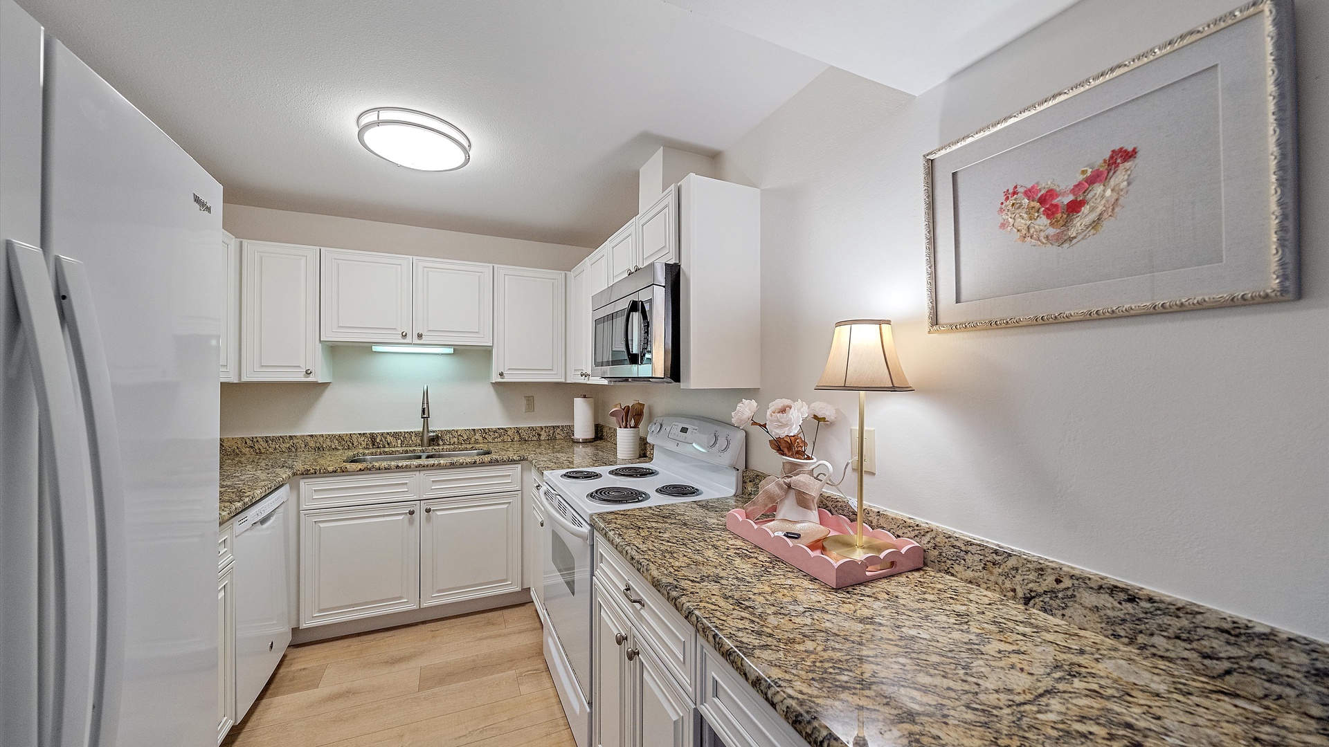 Your fully-equipped kitchen features granite countertops, white cabinetry, and all the appliances you need to prepare meals during your stay.