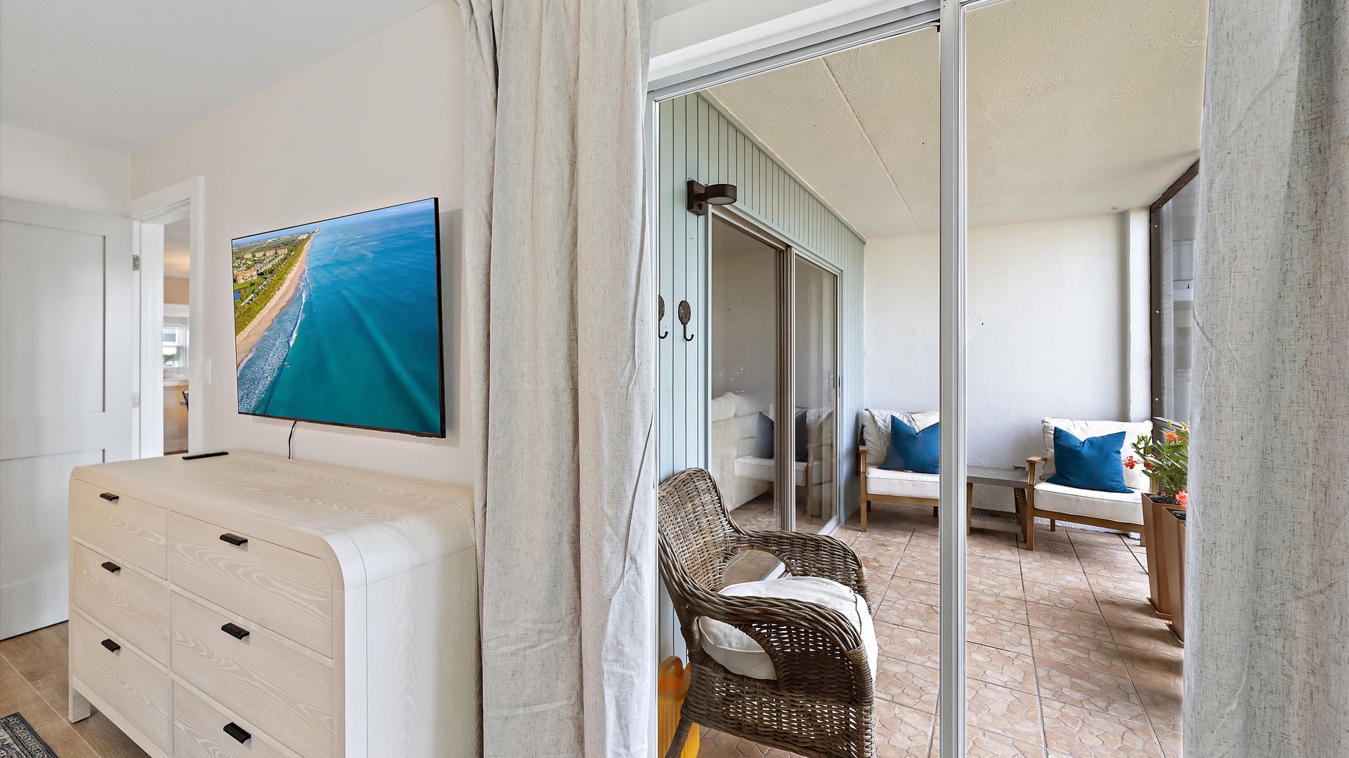 Your bright bedroom opens to a private terrace where you can unwind in wicker seating with beautiful views.