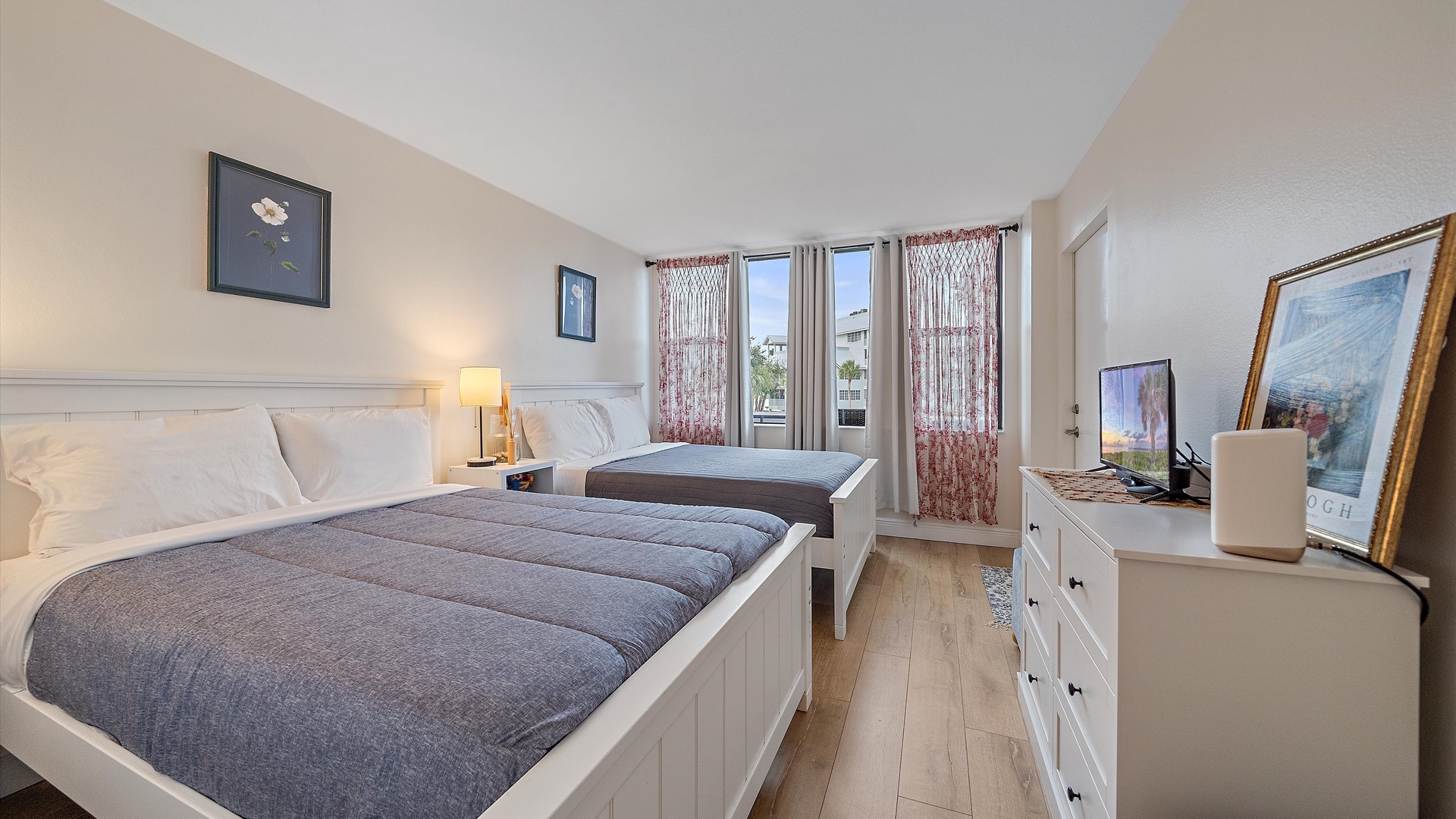 Relax in your comfortable twin bedroom with crisp white linens, modern amenities, and plenty of natural light streaming through the windows.