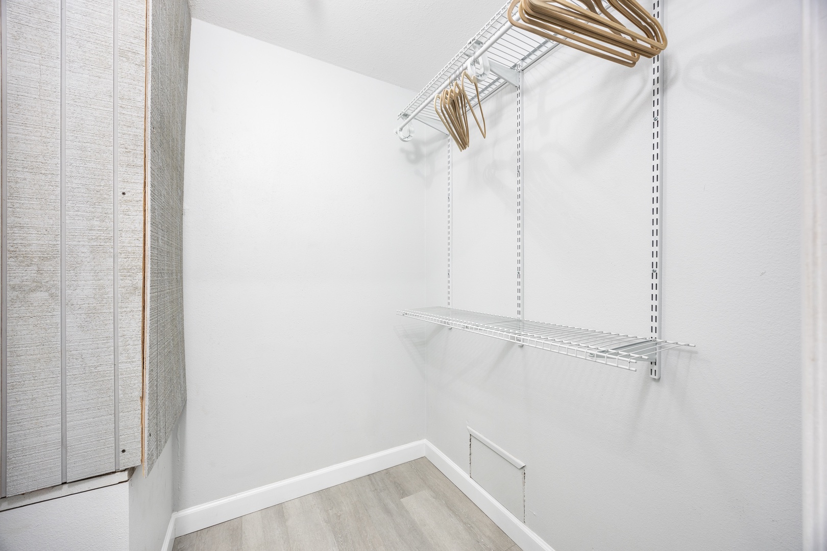 Your spacious walk-in closet features organized wire shelving and golden hangers, making it easy to unpack and stay organized throughout your stay.