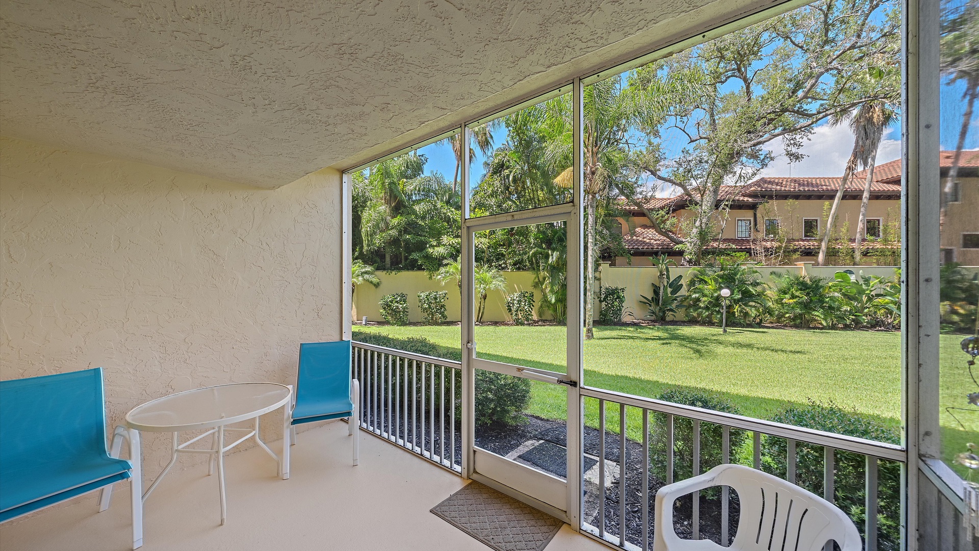 Unwind on your private screened patio overlooking lush tropical gardens and manicured lawns—your peaceful outdoor retreat awaits.