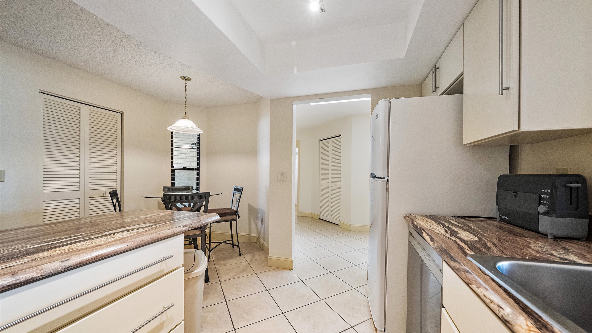 Your fully equipped kitchen awaits, with granite counters, modern appliances, and a bright dining nook—perfect for morning coffee or evening meals after exploring the area.