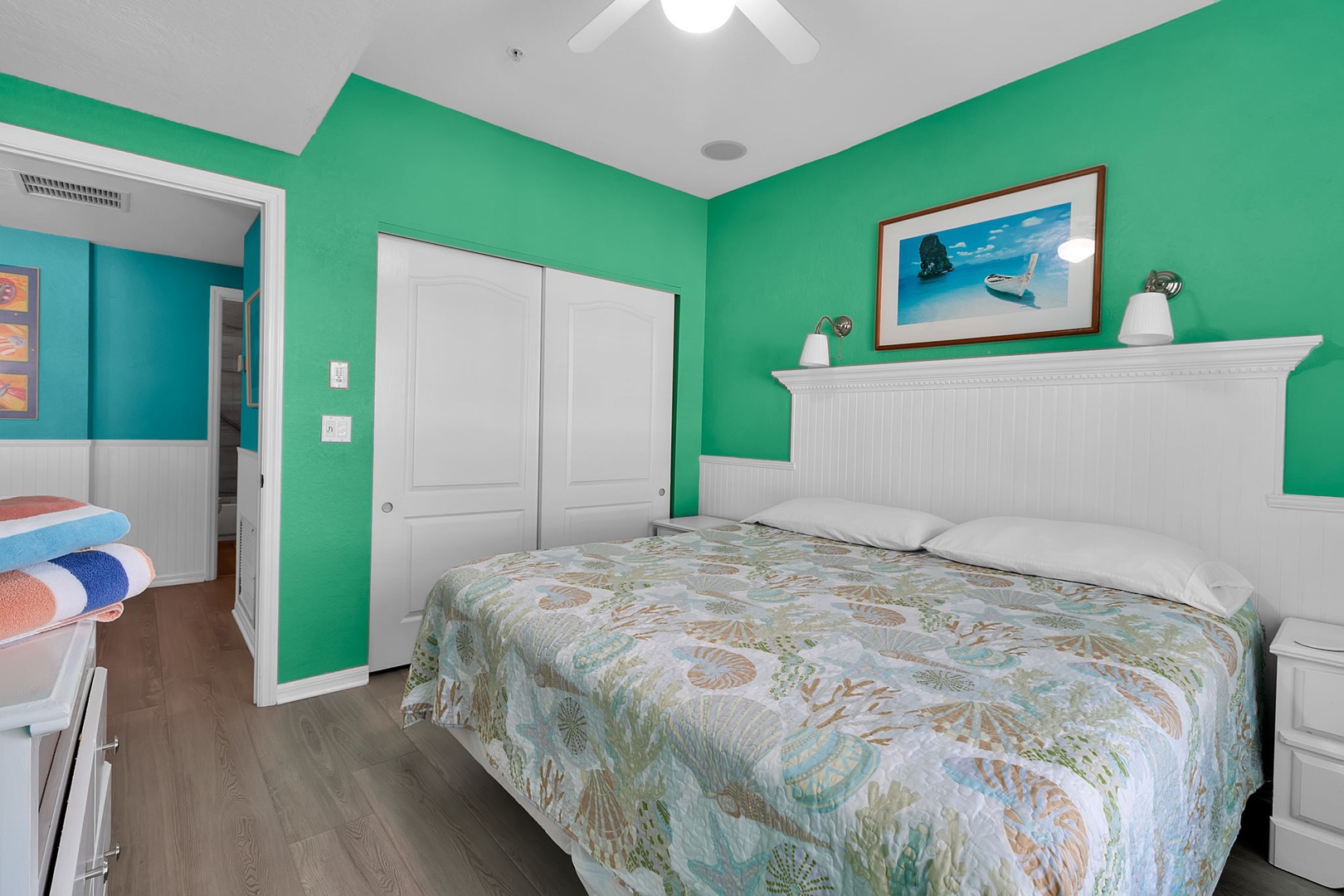 Sink into your coastal retreat, where vibrant turquoise walls and beach-themed touches set a cheerful, relaxing mood for your getaway.