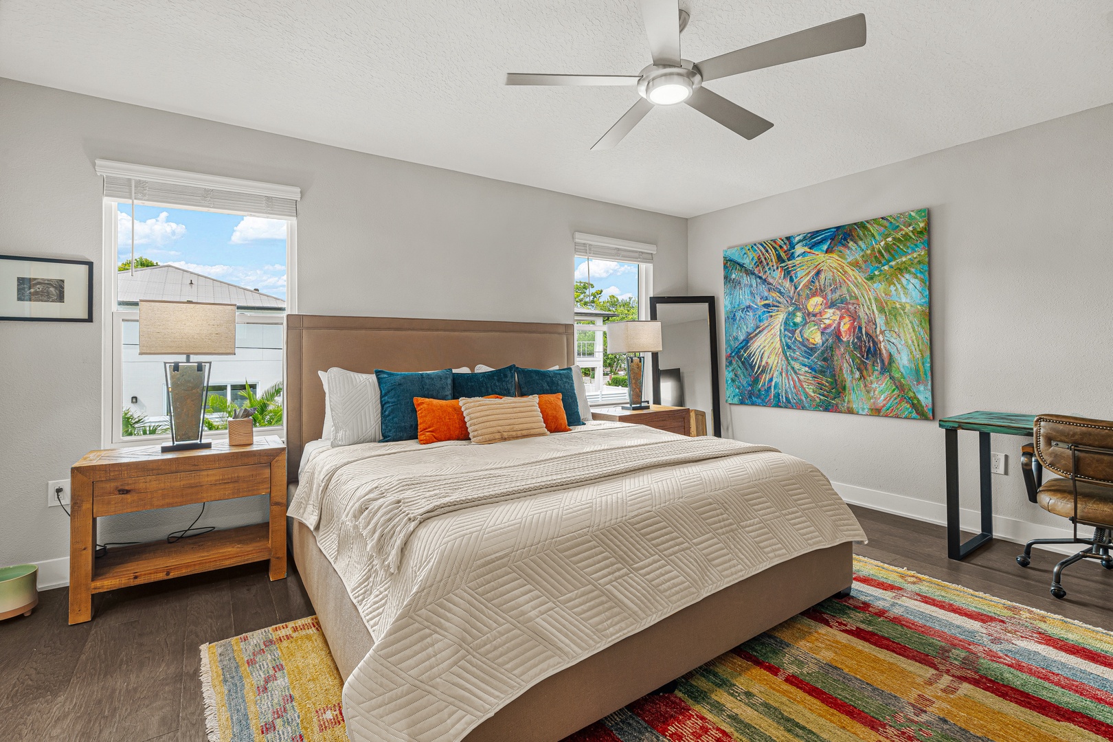 Unwind in the primary king bedroom with hotel-style linens, ensuite bathroom and soaking tub, plush towels, and Smart TV.