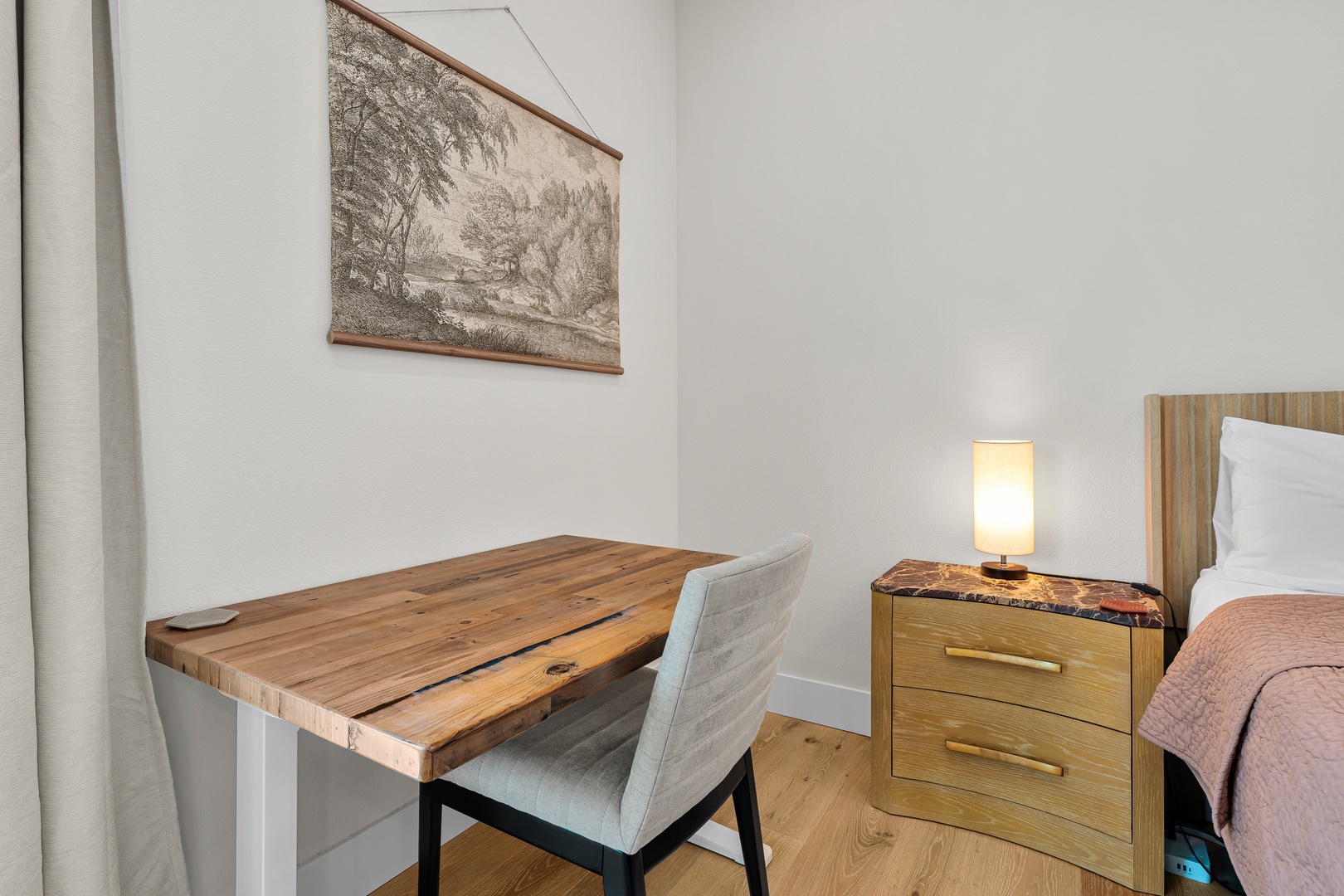 Your serene bedroom offers a peaceful retreat with a comfortable bed, rustic workspace, and thoughtful touches like soft lighting and unique décor to make you feel right at home.