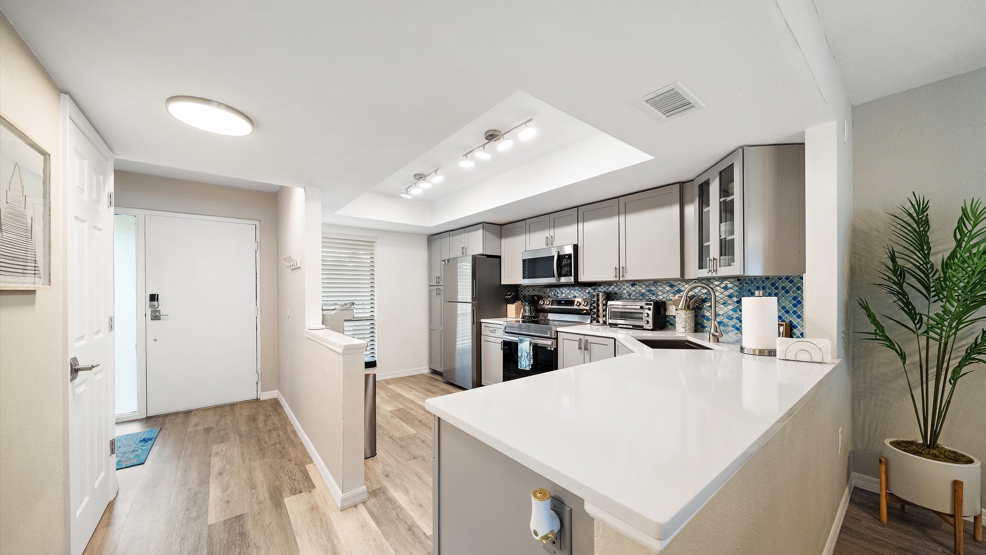 Your fully equipped kitchen features sleek countertops, stainless steel appliances, and a spacious island perfect for preparing meals or gathering with loved ones.