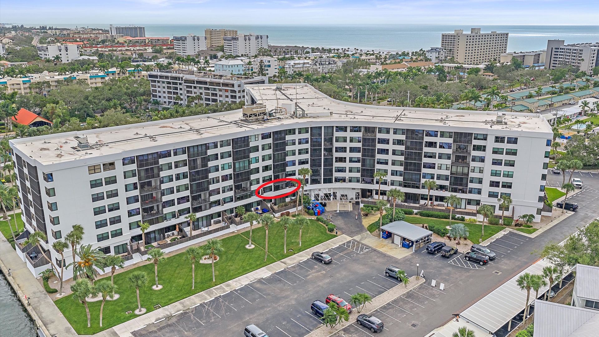 Aerial view of the beachside resort complex and surrounding coastal area with nearby hotels and amenities.