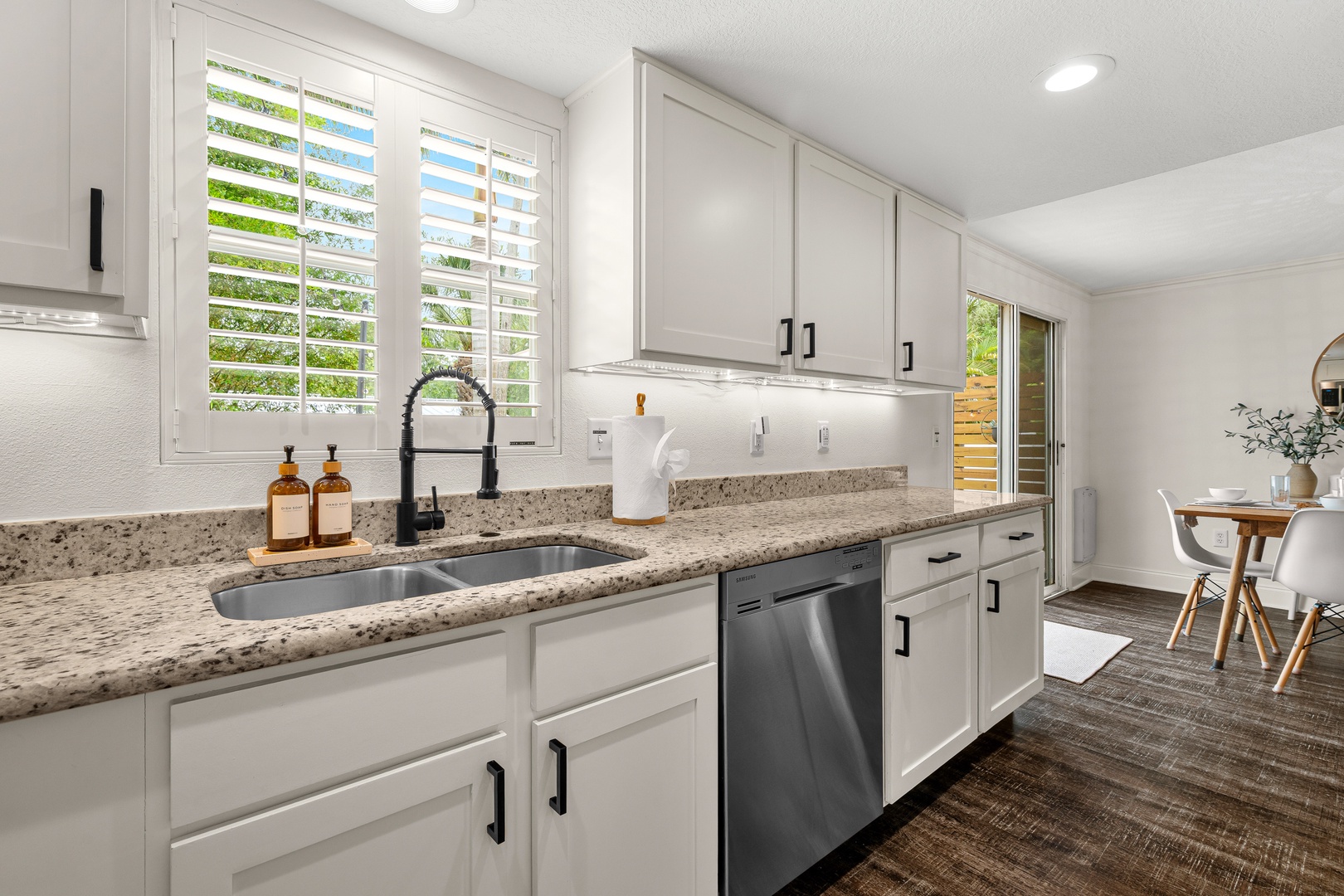 Step into your well-appointed kitchen with sleek granite counters, stainless appliances, and abundant natural light streaming through plantation shutters—perfect for preparing your favorite meals.