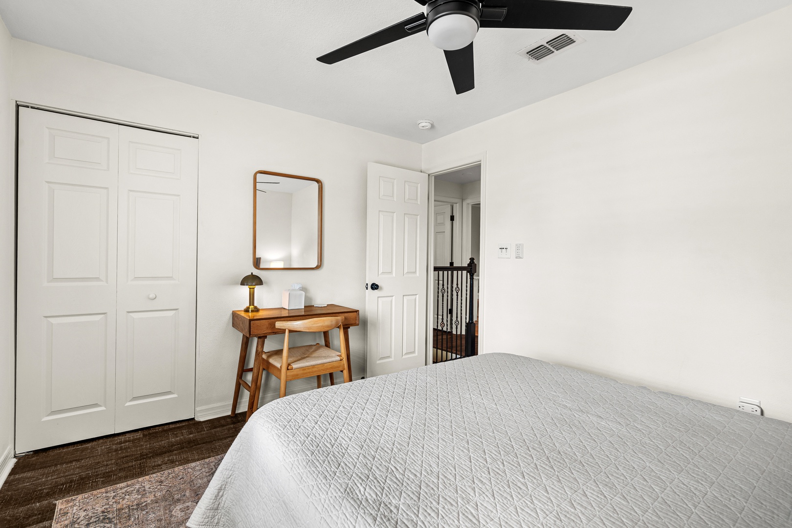 Your peaceful bedroom features a comfy bed, stylish workspace, generous closet storage, and a ceiling fan to keep you cool and comfortable throughout your stay.