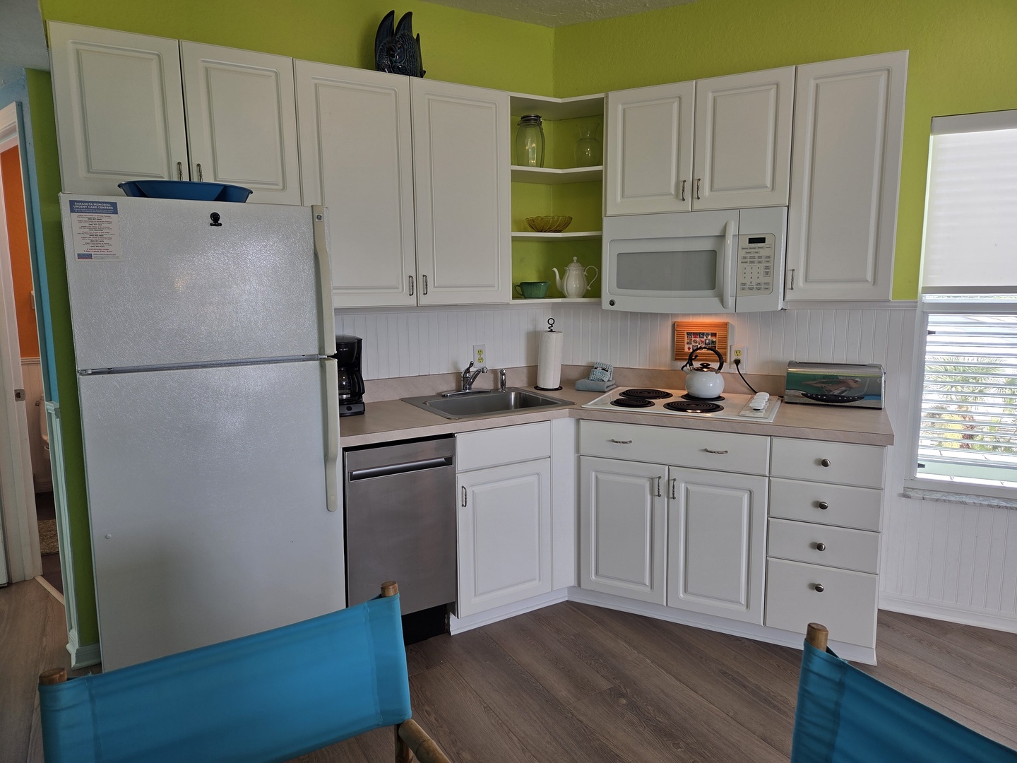 Your bright, cheerful kitchen comes fully equipped with everything you need, from the full fridge and dishwasher to the stove and microwave—ready for easy meals between beach trips.