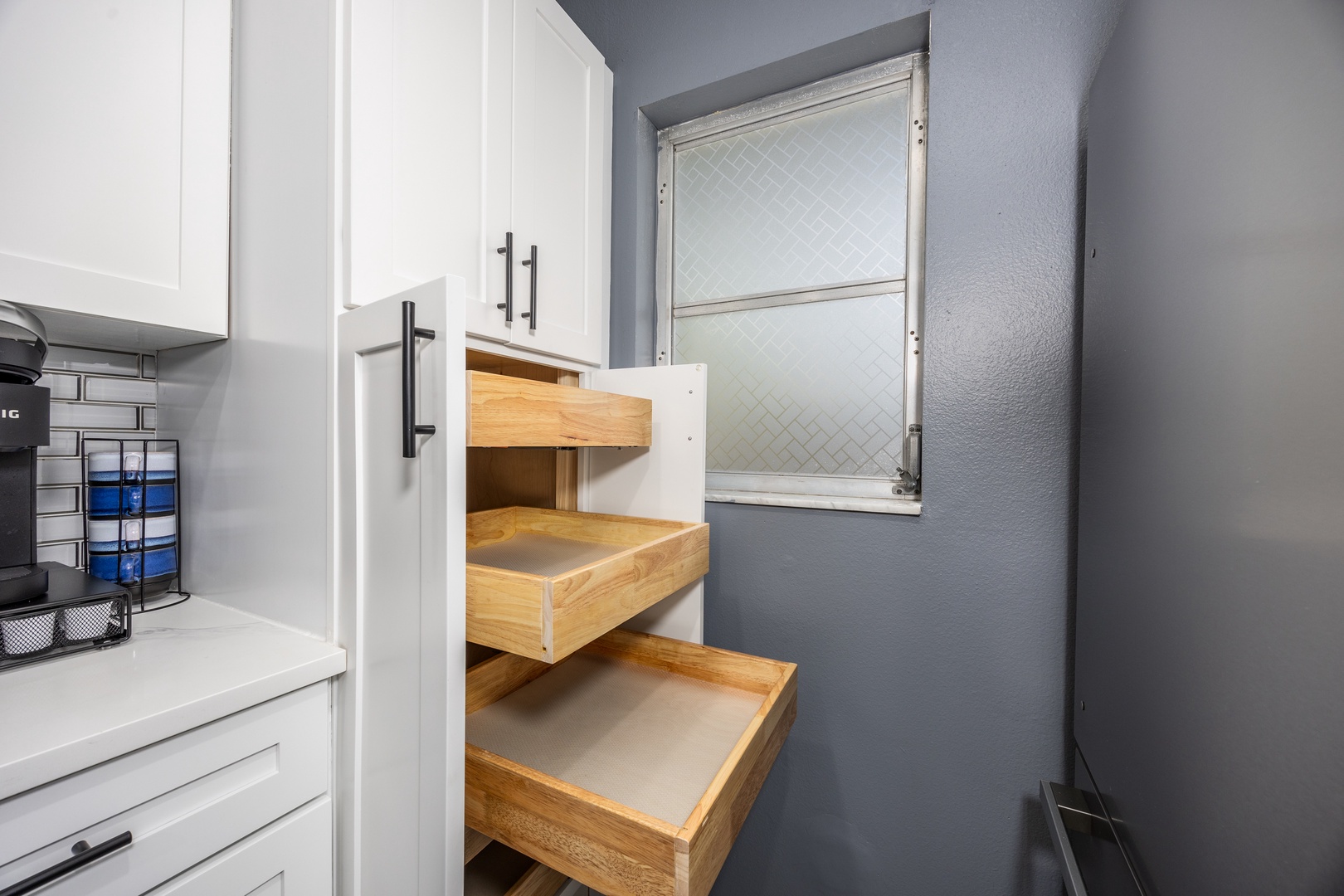 Your well-appointed kitchen features smart pull-out drawers that make accessing your essentials effortless during your stay.