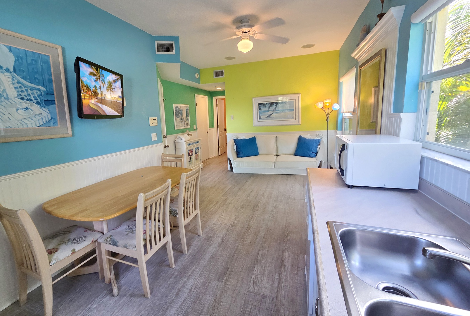 Your bright, open-plan retreat combines cheerful coastal colors with everything you need to feel at home—cozy seating, a dining area, and a full kitchen ready for easy meals between beach adventures.