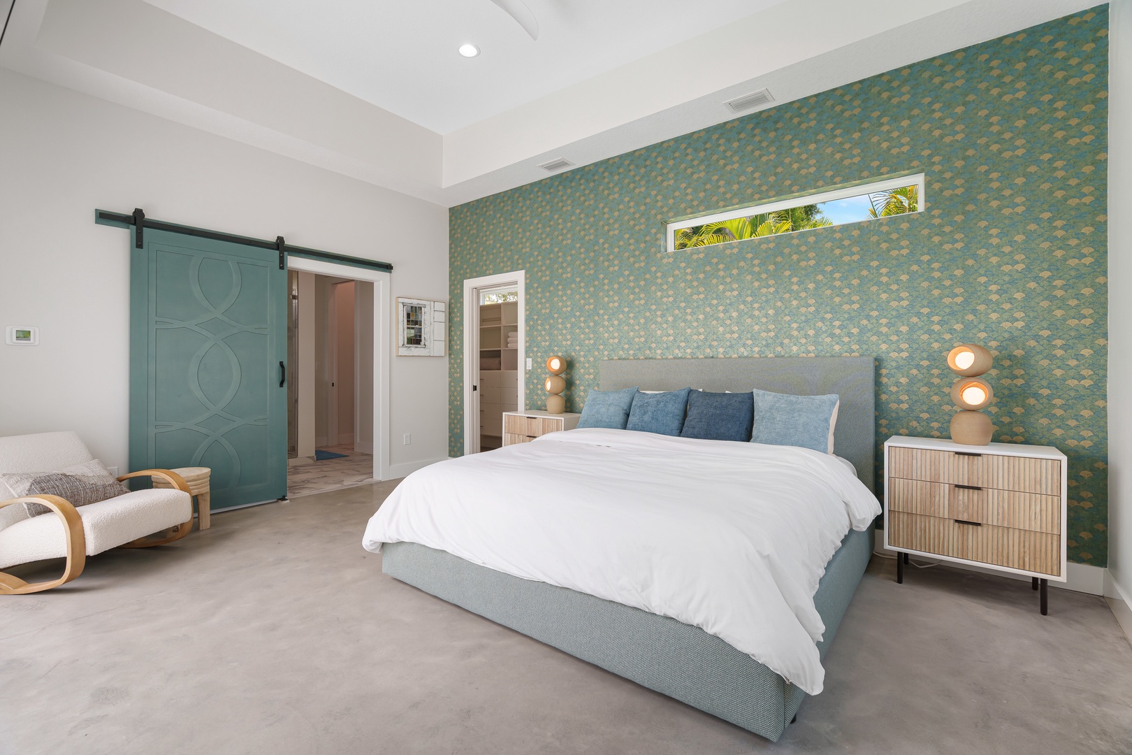 Unwind in your spacious bedroom with a stunning textured accent wall and plush bedding. The charming barn door adds character, while warm lighting creates a cozy ambiance for restful nights.