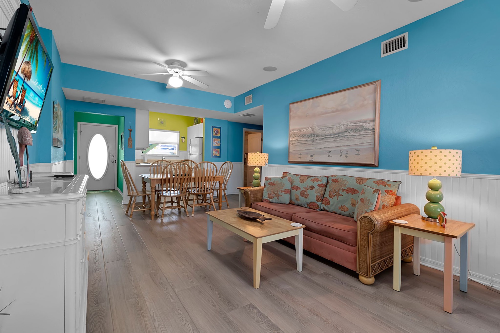 Step into your bright, beachy home away from home, where turquoise walls and coastal artwork set a relaxing mood. Unwind on the cozy sofa, gather around the dining table, and feel the vacation vibes wash over you.