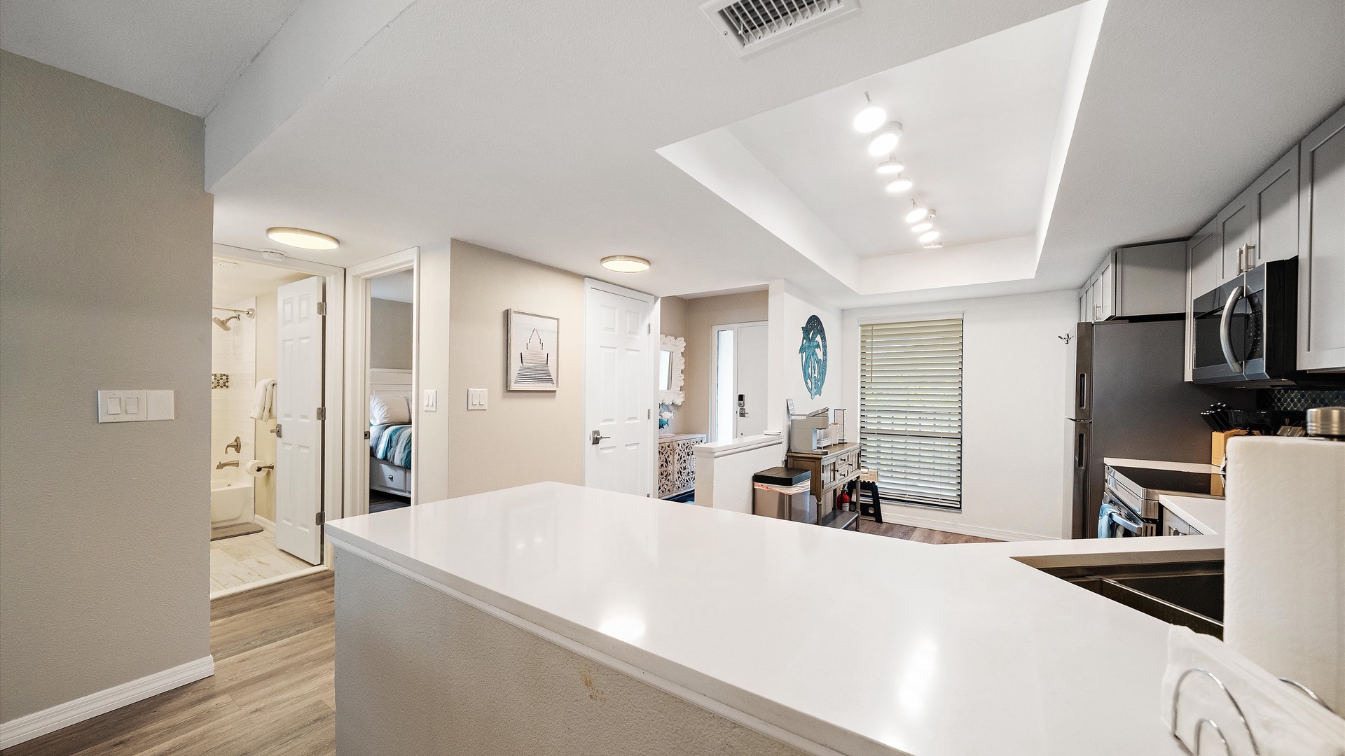 Step into a bright, open space where kitchen, dining, and living areas flow seamlessly together. Modern finishes and plenty of natural light create an inviting atmosphere for your stay.