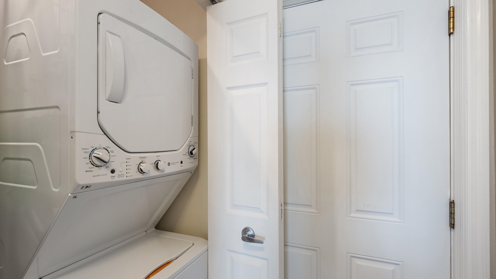 Private in-unit laundry adds everyday convenience to an extended island stay. The stacked washer and dryer are neatly tucked into their own closet.