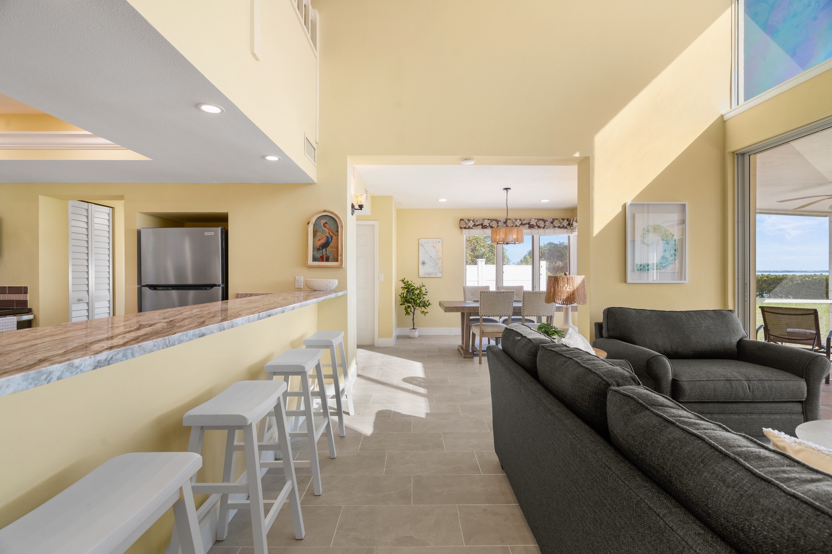 Unwind in this bright, open-concept living space where you can gather around the stylish breakfast bar or sink into the plush sectional sofa.