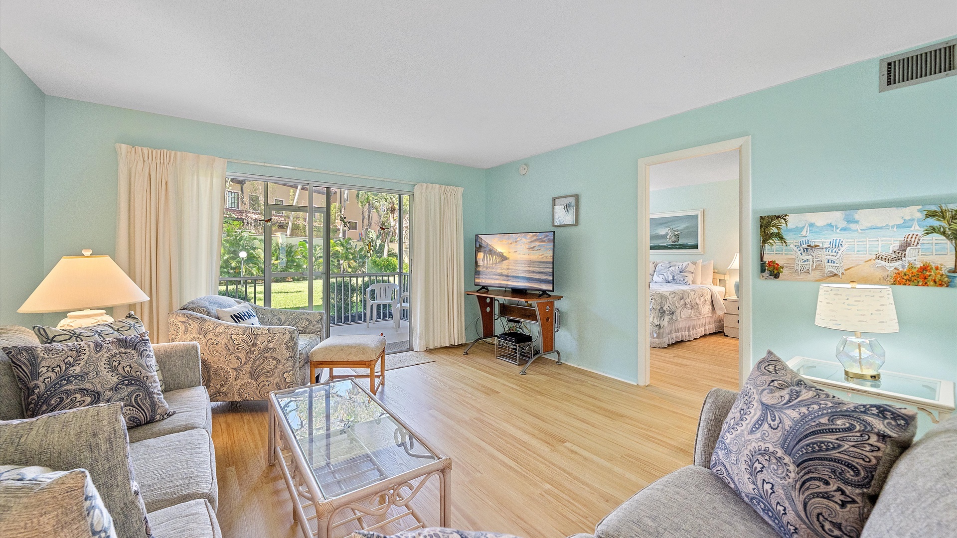 Your bright coastal retreat features comfortable seating, beachy décor, and a private balcony overlooking lush grounds. Soft aqua walls and coastal artwork make relaxation effortless.