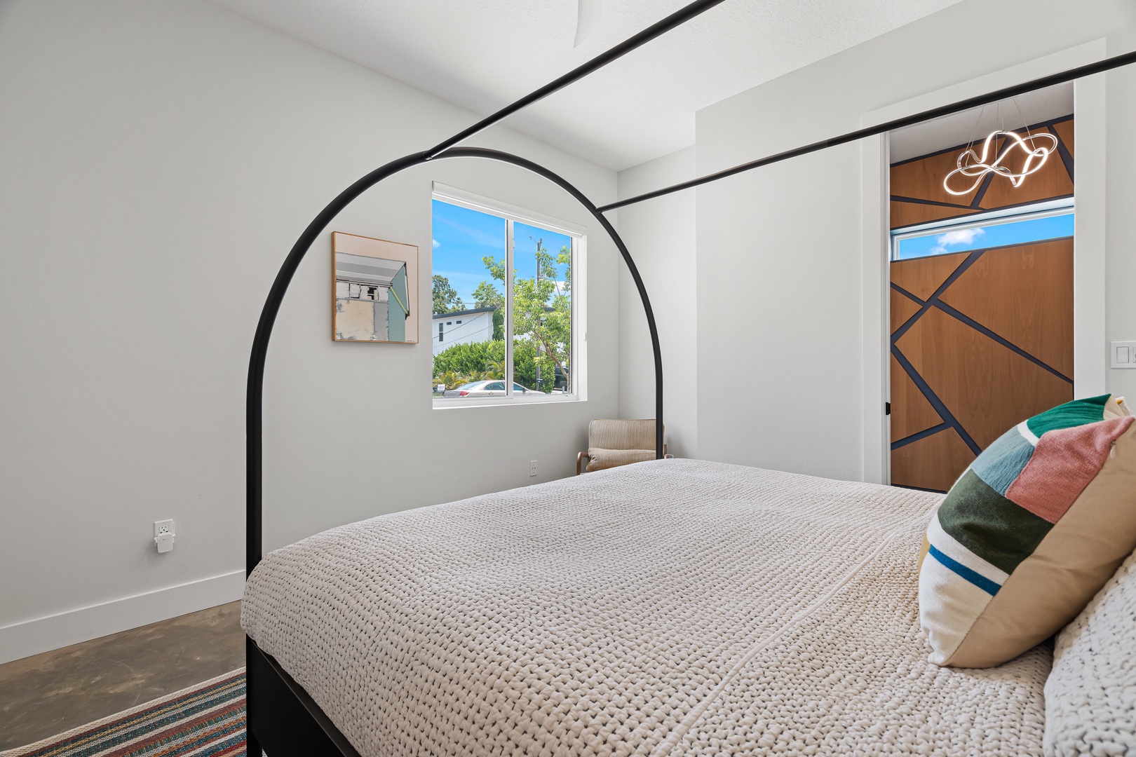Sink into plush comfort after your adventures. Your bedroom features a cozy bed, modern arched frame, and plenty of natural light to wake up refreshed each morning.
