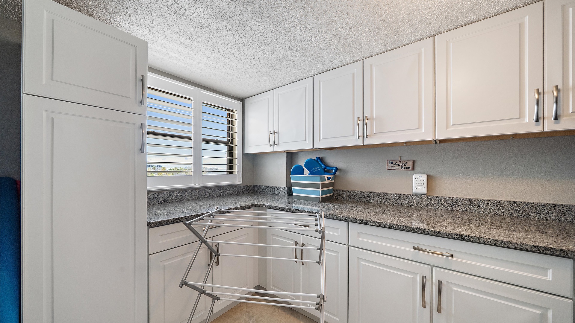 Your fully equipped kitchen features white cabinets and granite countertops, perfect for preparing meals during your stay.