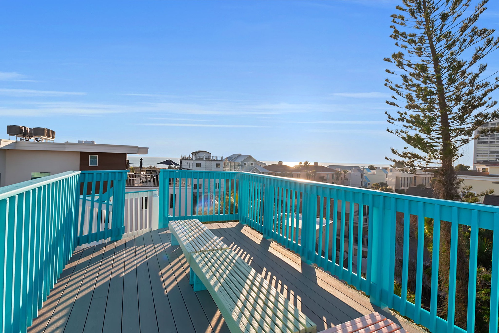 A bright turquoise deck offers your own elevated outdoor retreat with open skies and neighborhood views, perfect for morning coffee or sunset cocktails.