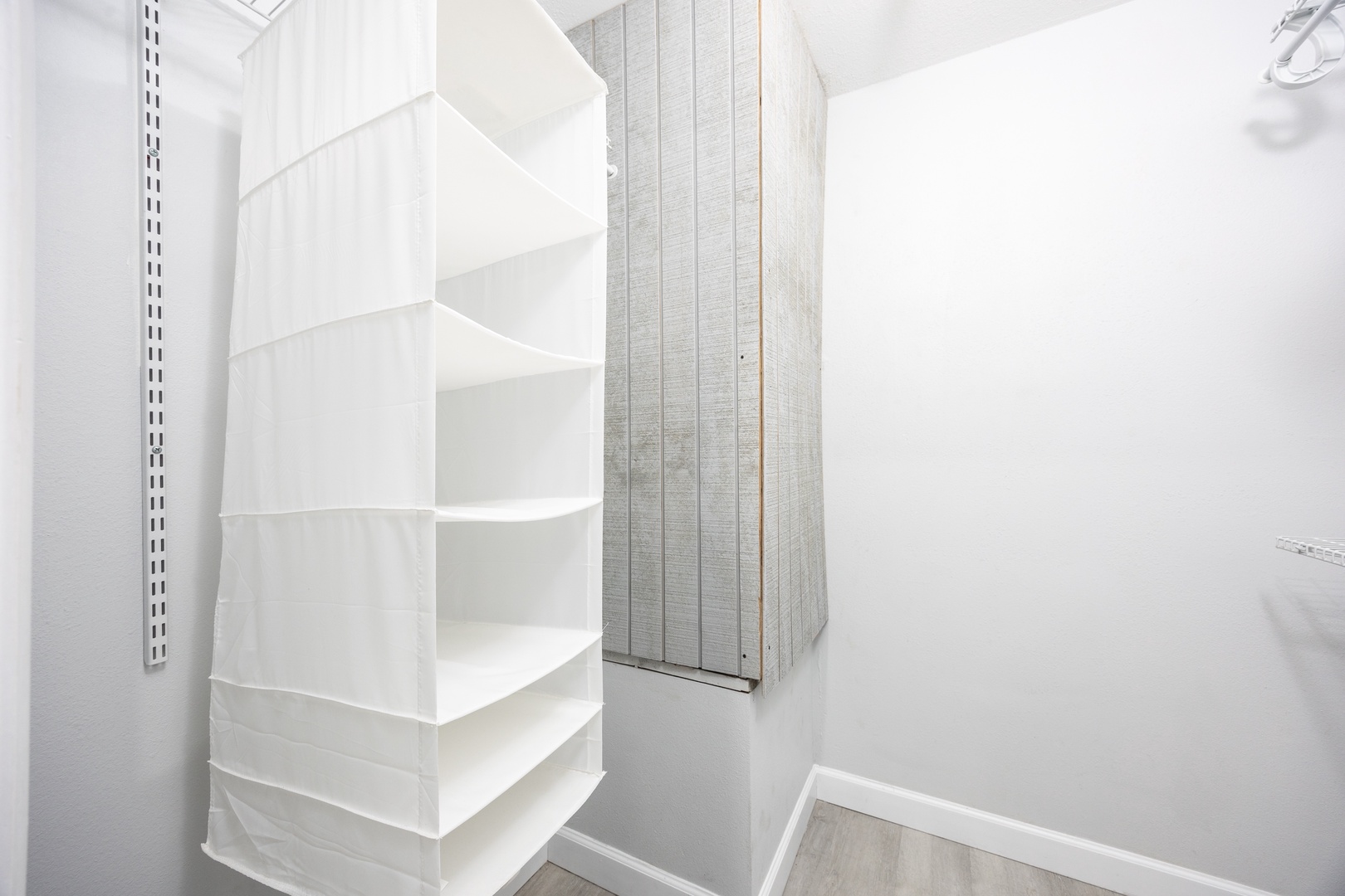 Your spacious walk-in closet offers ample storage with built-in shelving and a sleek wardrobe, keeping your belongings perfectly organized.
