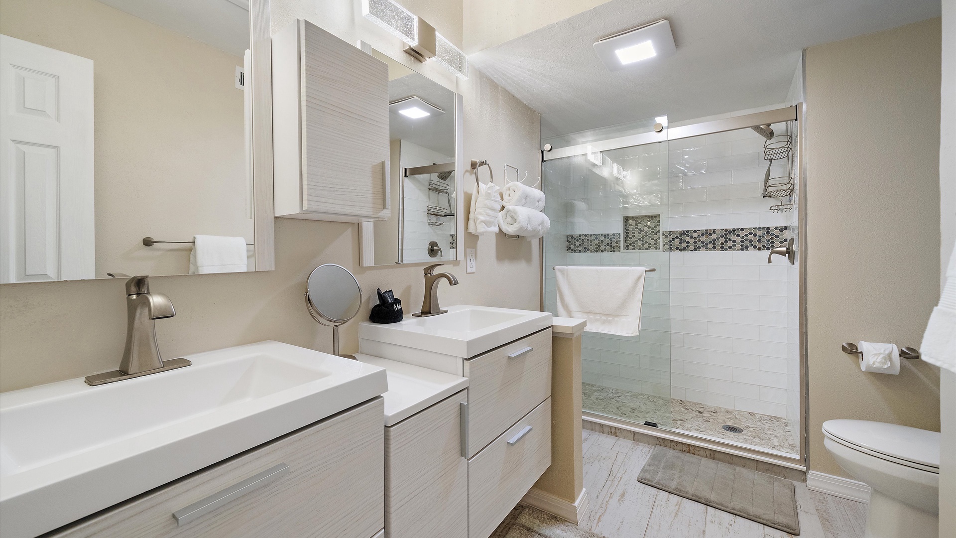 Step into your serene spa-inspired primary bathroom with dual vanities, stylish fixtures, and a beautiful walk-in shower. Fluffy towels and thoughtful details make your morning routine feel effortlessly luxurious.