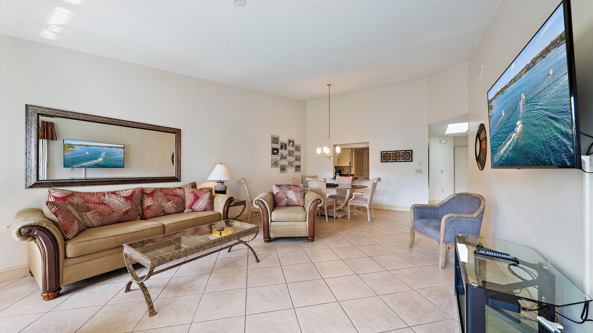 Sink into plush sofas and unwind in your open living space, where vaulted ceilings and coastal artwork create a breezy, welcoming retreat for your stay.