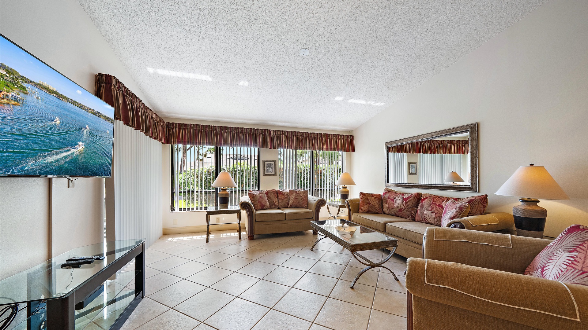 Relax in your spacious living room featuring comfortable seating, large windows framing lush greenery, a bright open layout, and all the comforts you need to unwind after your adventures.