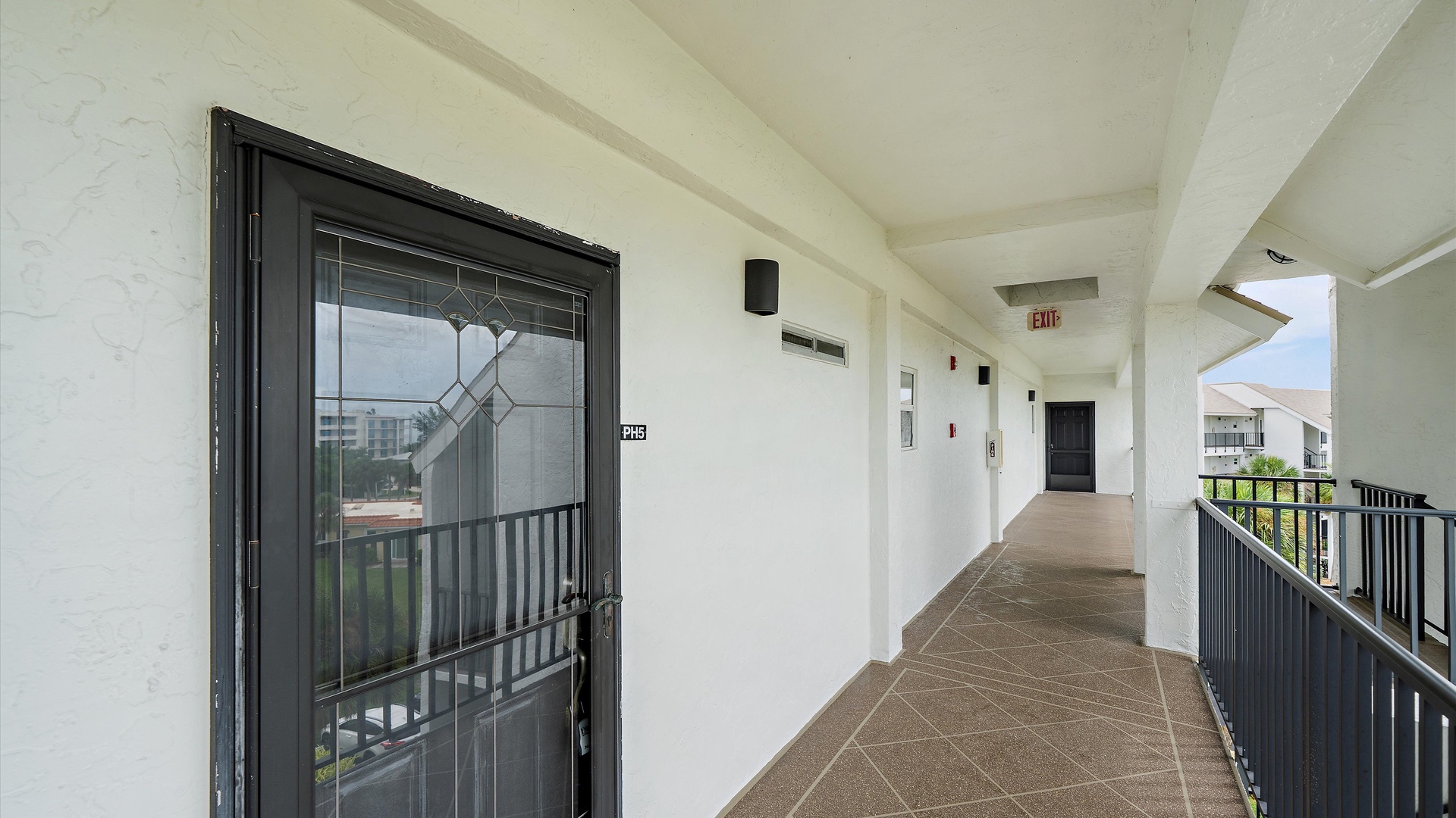 A covered exterior walkway leads to the condominium entrances. This final view shows the building’s approach and entry setting before you step inside your Windward Bay retreat.