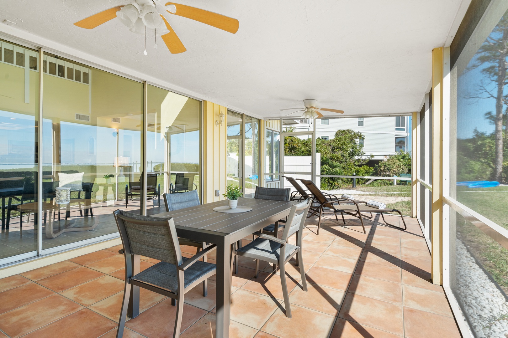 Your screened patio offers perfect breezy dining with ceiling fans keeping you cool while you savor meals surrounded by lush garden views.